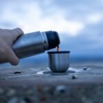 Pouring coffee from the flask at the summit of Ivinghoe Beacon before sunrise