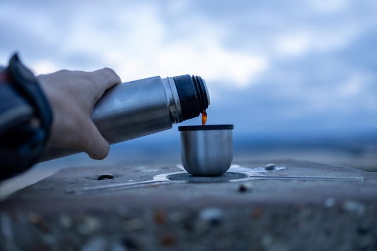 Pouring coffee from the flask at the summit of Ivinghoe Beacon before sunrise