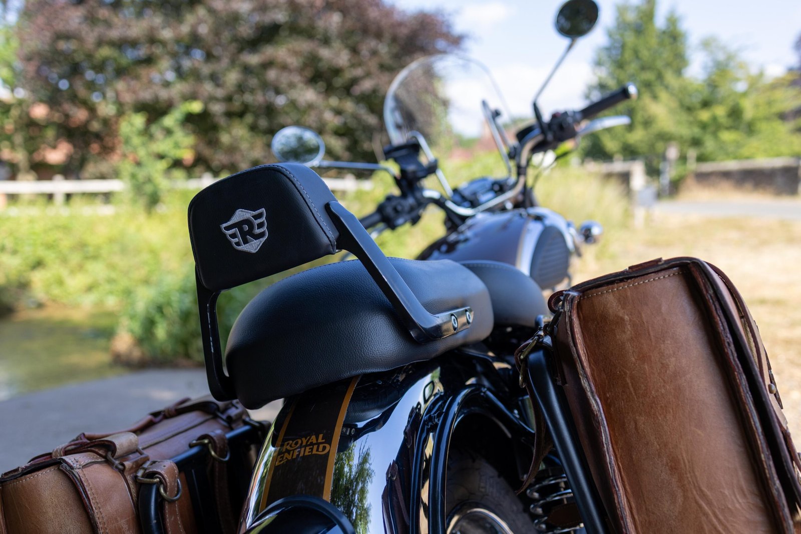 Rear view of the Royal Enfield Classic 350's seat backrest and leather panniers at the ford crossing
