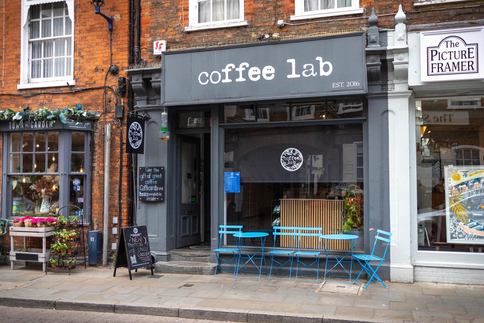 Coffee Lab shop front on the high street in Hitchin, with turquoise outdoor bistro tables and chairs