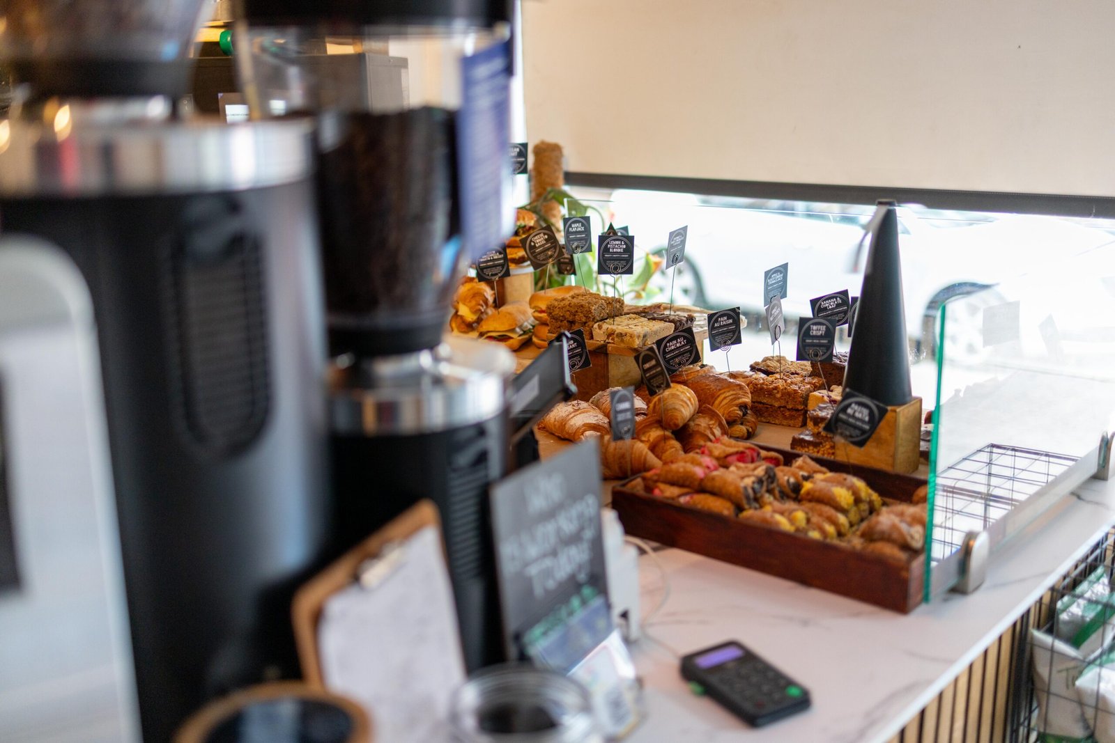Pastry counter at Coffee Lab in Hitchin, with croissants, flapjacks and cakes labelled with tasting notes