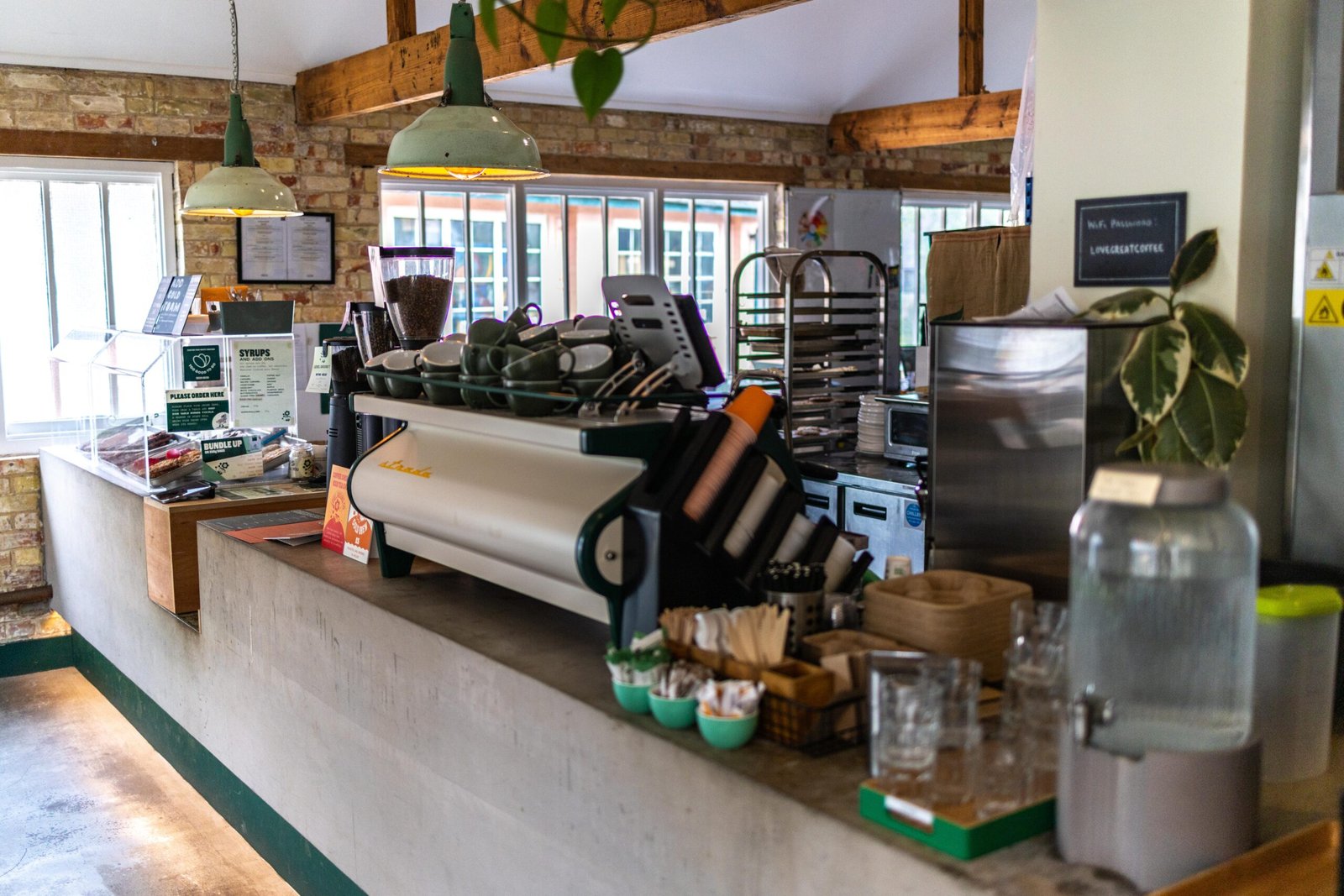 Espresso machine and counter inside Level Ground Co, Letchworth Garden City, with exposed brick and beam ceiling