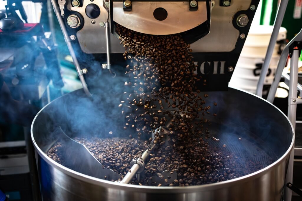 Coffee beans dropping into the cooling tray of the roaster at Level Ground Co in Letchworth Garden City