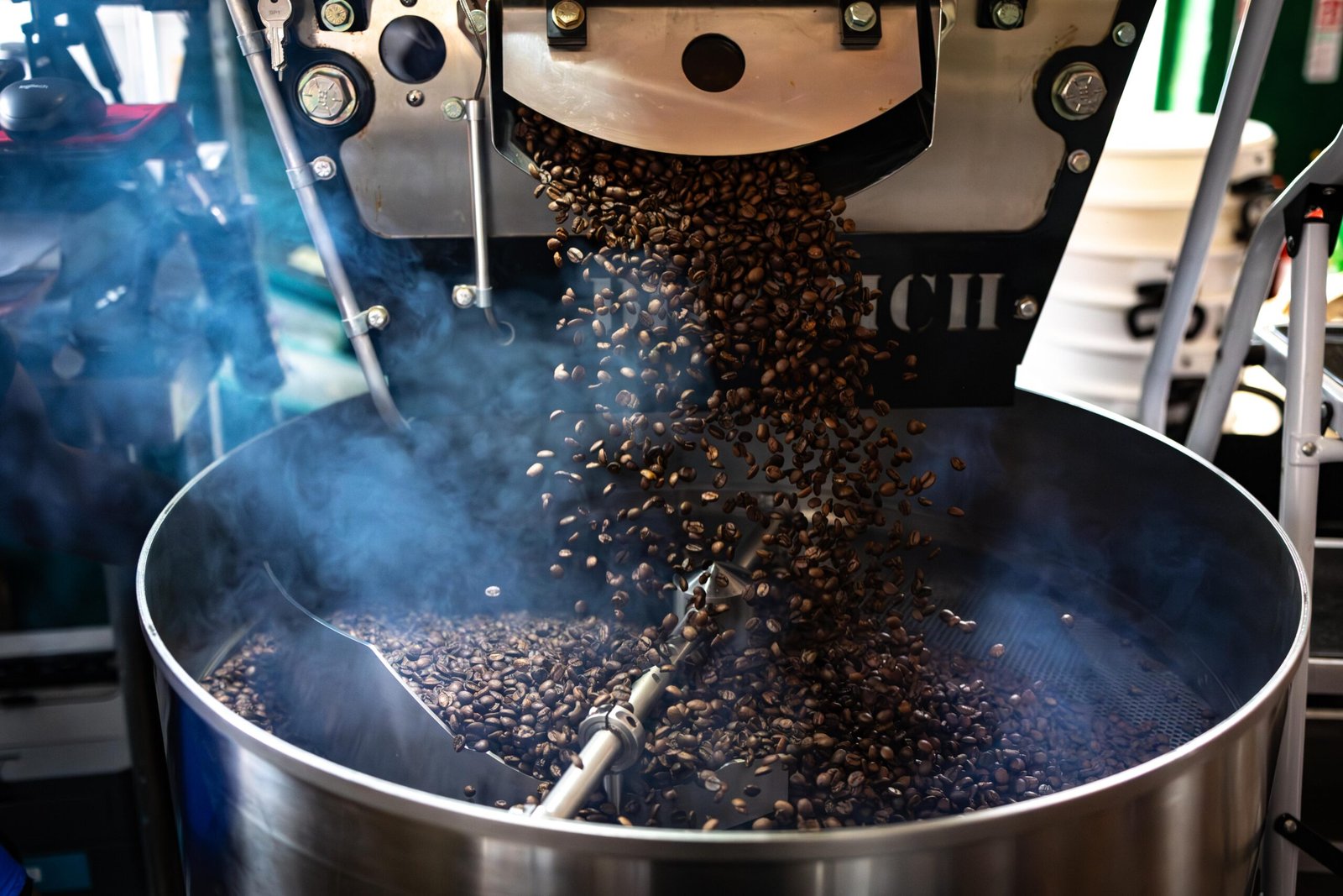 Coffee beans dropping into the cooling tray of the Diedrich roaster at Level Ground Co