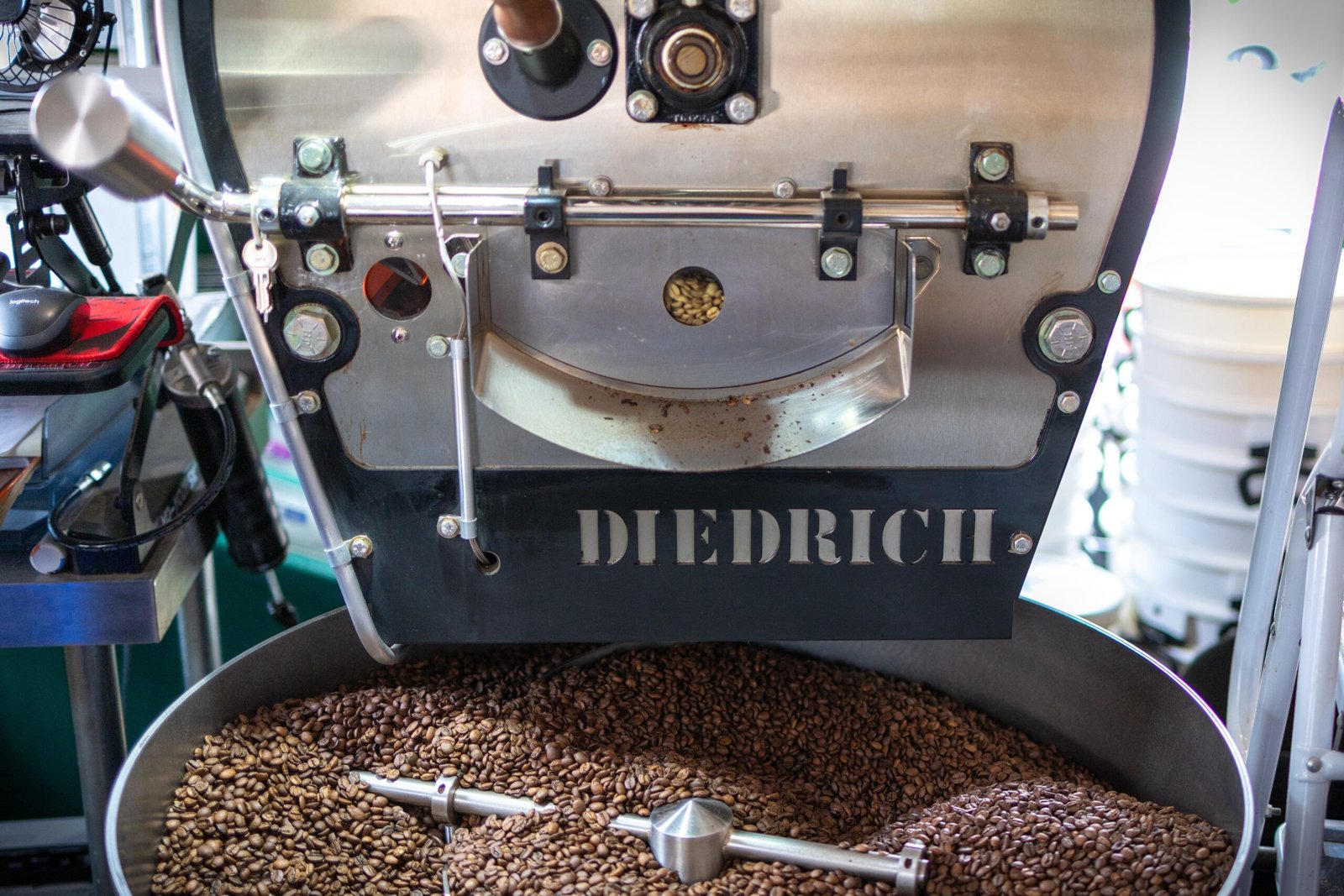 Close-up of the Diedrich roaster at Level Ground Co, with coffee beans cooling after roasting
