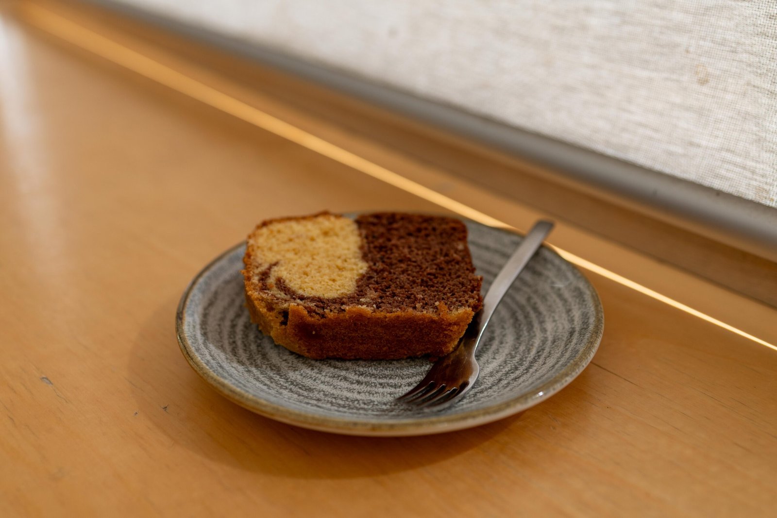 A slice of marble cake on a plate at Velasquez and Van Wezel
