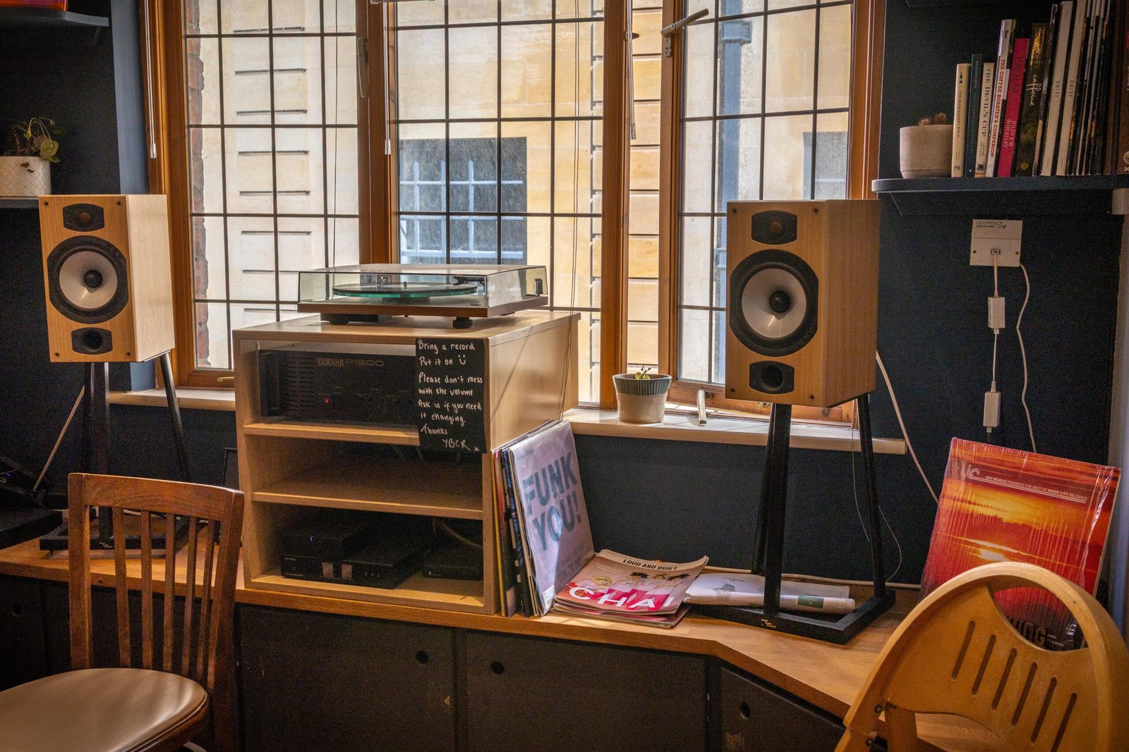 A record player and speakers by the window at Yellow Bourbon on Angel Street