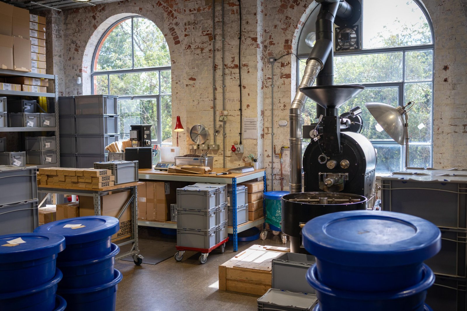 The roasting area at Yellow Bourbon's Weedon Depot, with the roaster set against arched windows and exposed brick