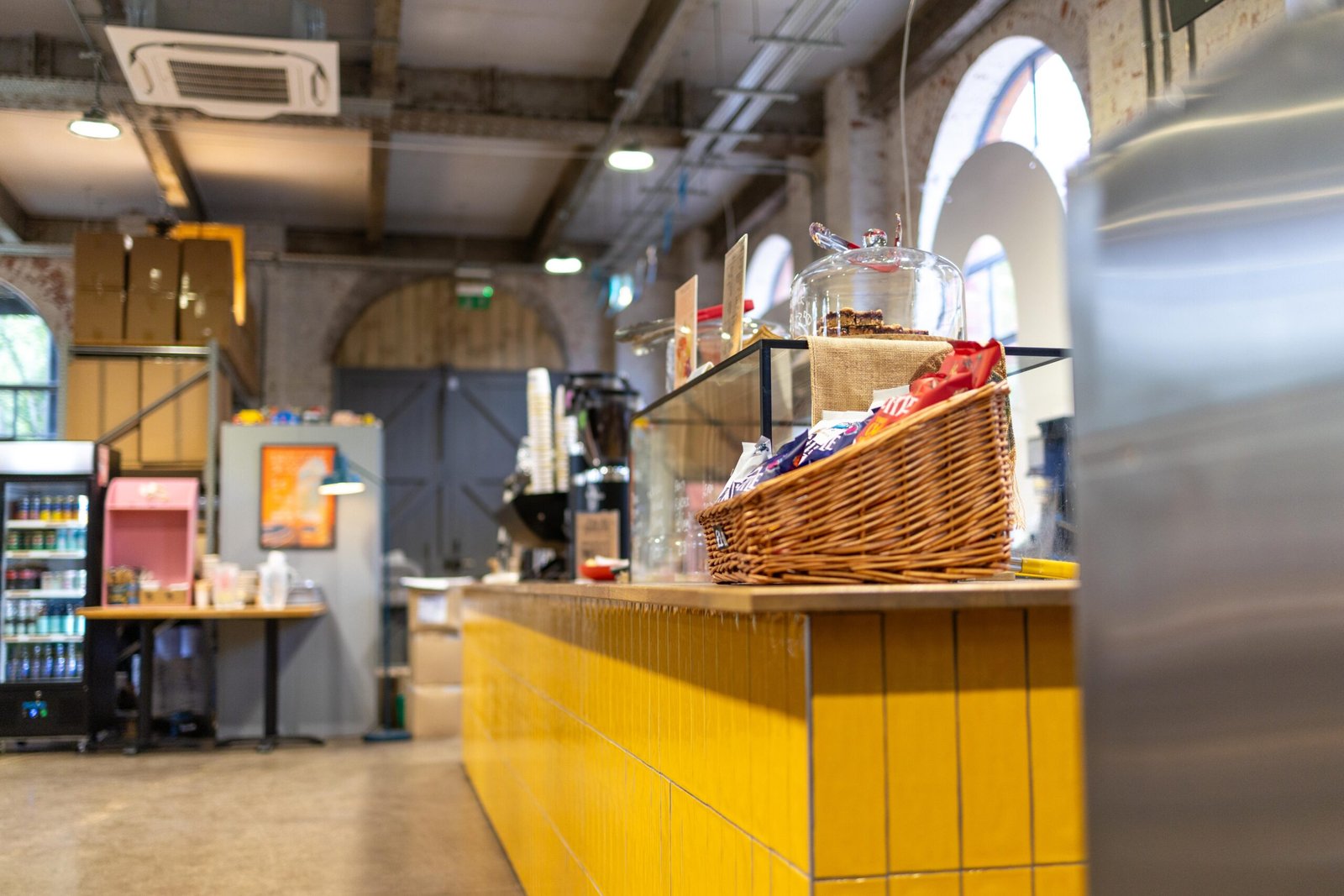 The yellow-tiled counter at Yellow Bourbon's Weedon Depot, with arched windows and exposed brick behind