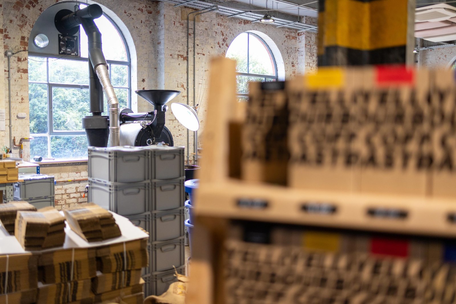 The roasting area at Yellow Bourbon's Weedon Depot, with stacked retail boxes in the foreground