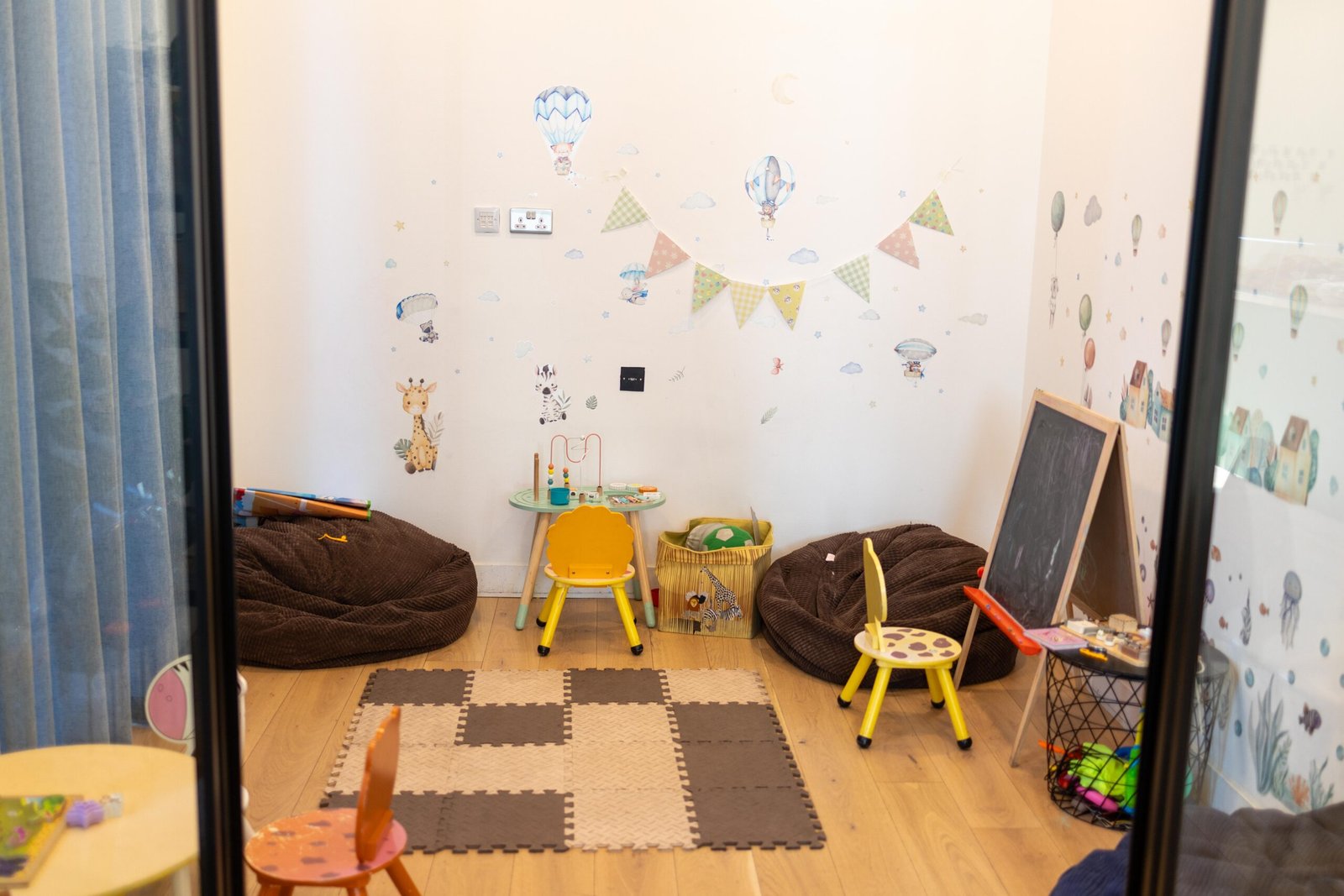 The dedicated kids' play area at Holy Grain & Brew, with bean bags and a chalkboard easel