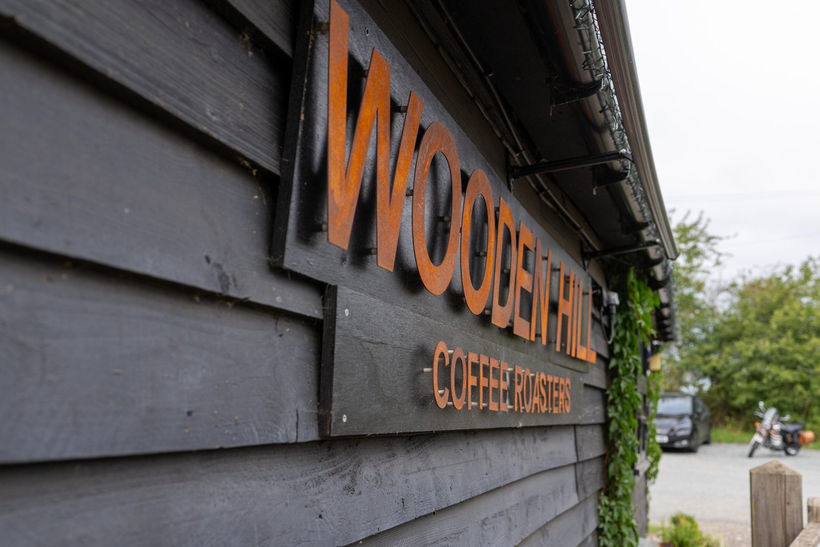 The Wooden Hill Coffee Roasters sign on the exterior of the Haynes site