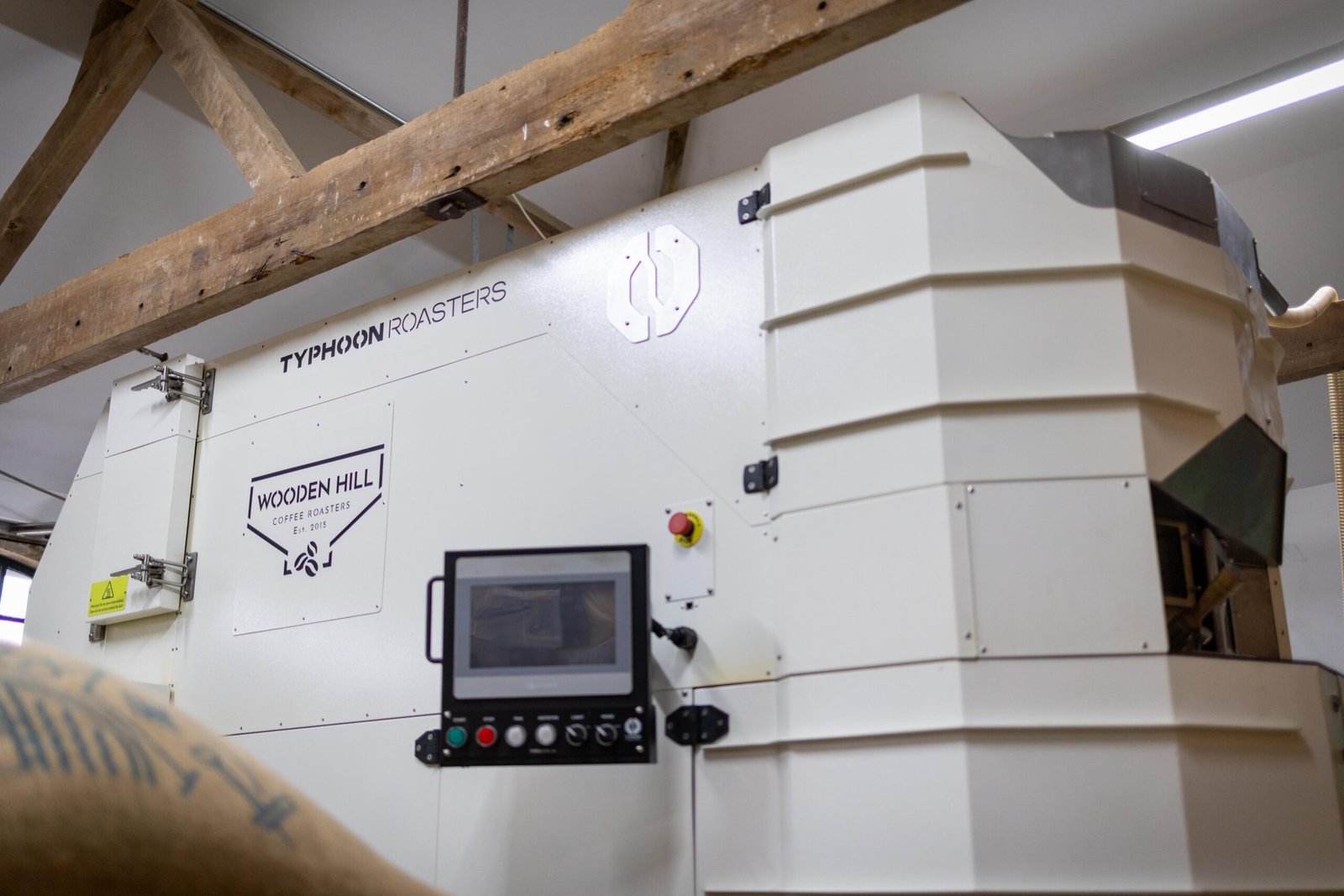 The Typhoon Roasters coffee roasting machine at Wooden Hill Haynes, branded with the company logo
