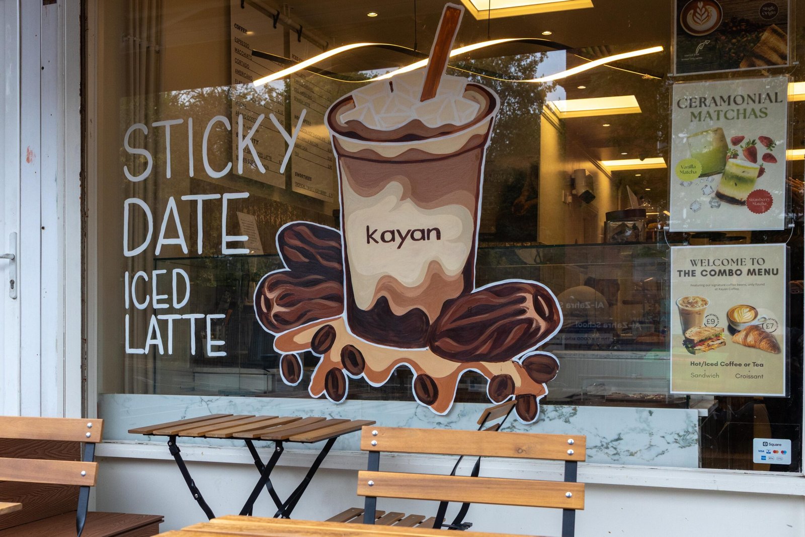 Close-up of the Sticky Date Iced Latte artwork painted on the front window of Kayan Specialty Coffee