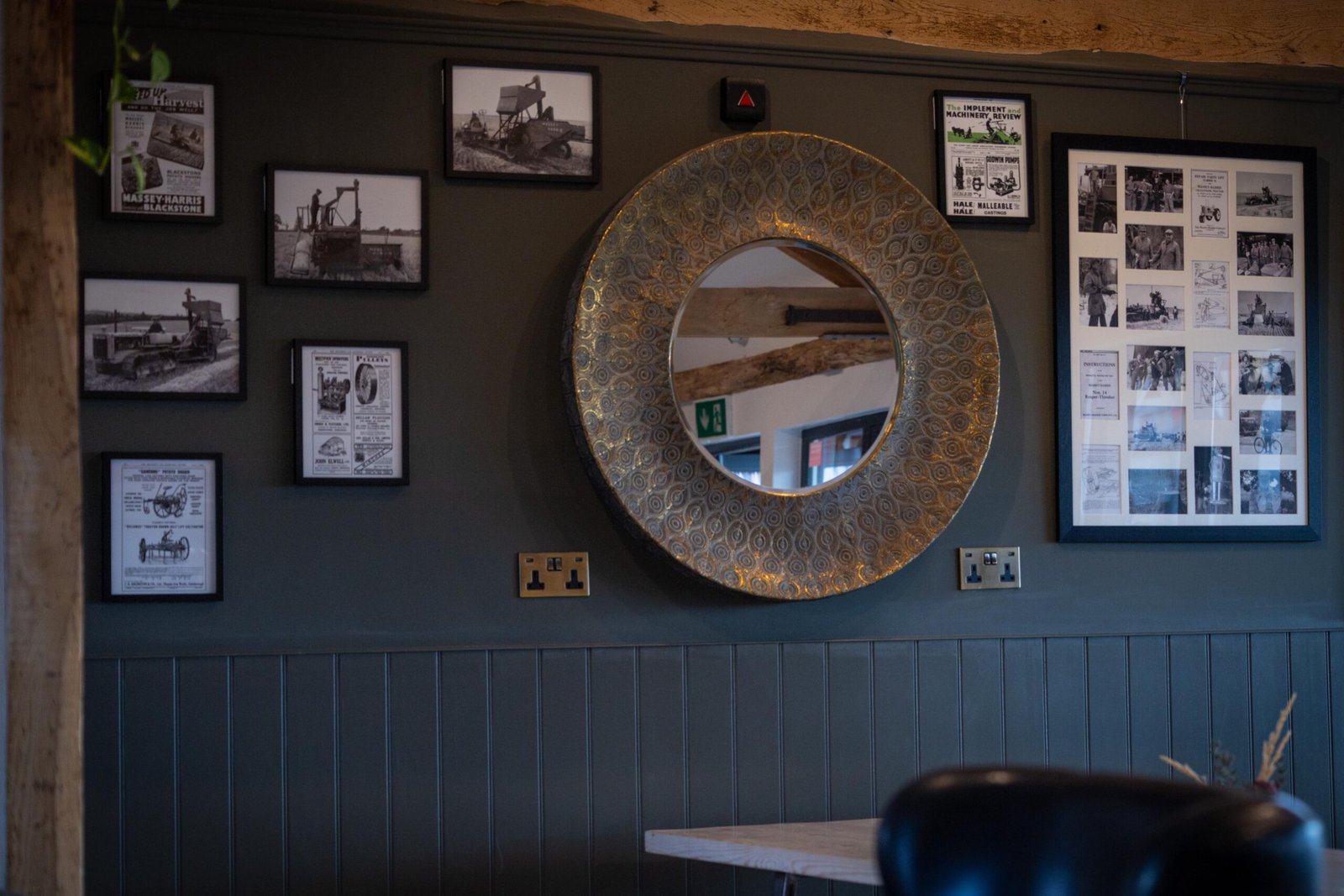 Vintage farm machinery photographs and adverts on the wall at The Mixing Shed Cafe