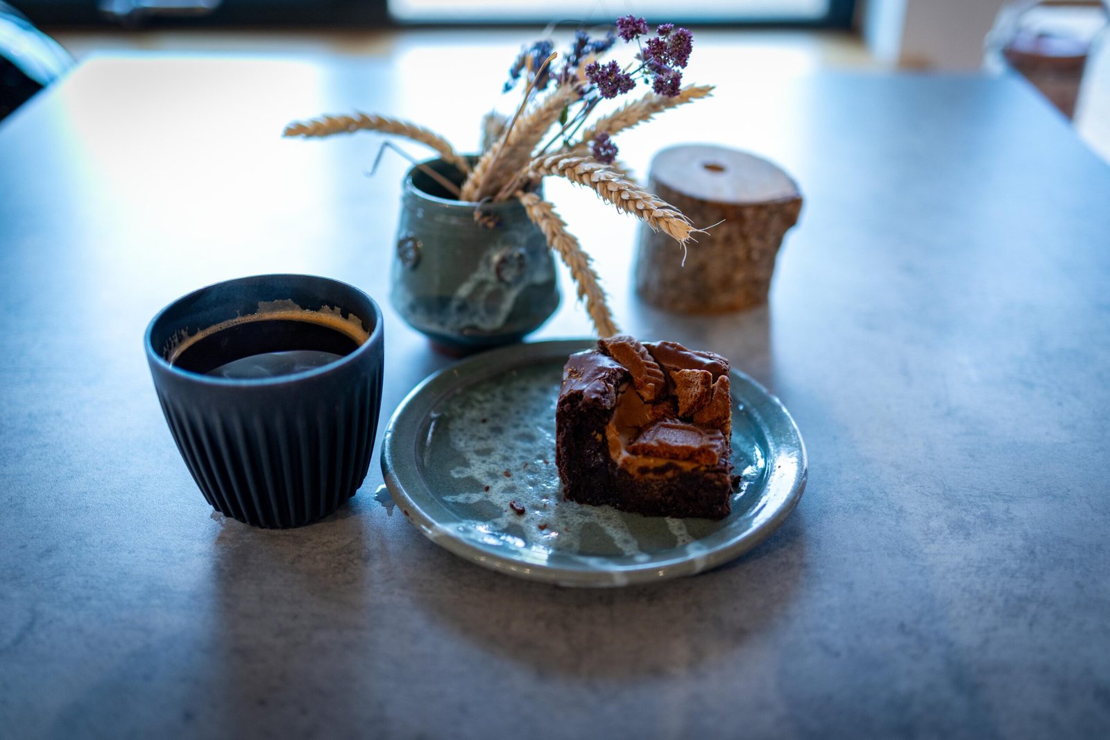 Coffee and a chocolate caramel brownie on a table at The Mixing Shed Cafe
