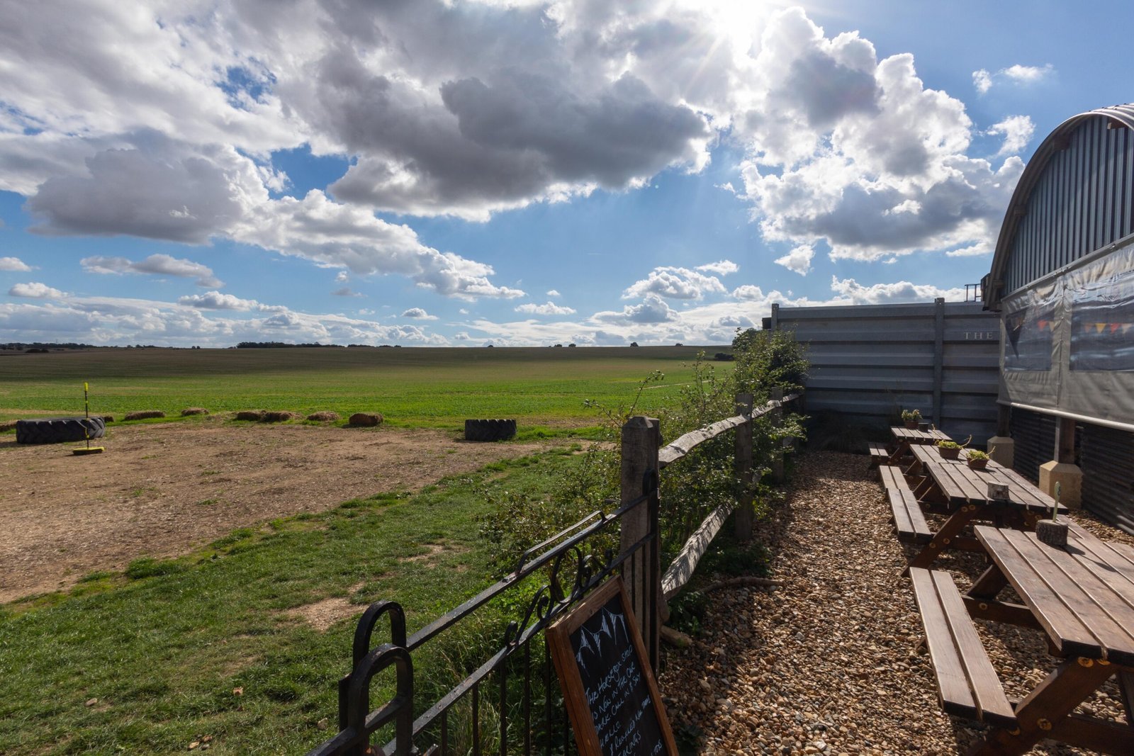 Outdoor picnic table seating at The Mixing Shed Cafe overlooking open countryside