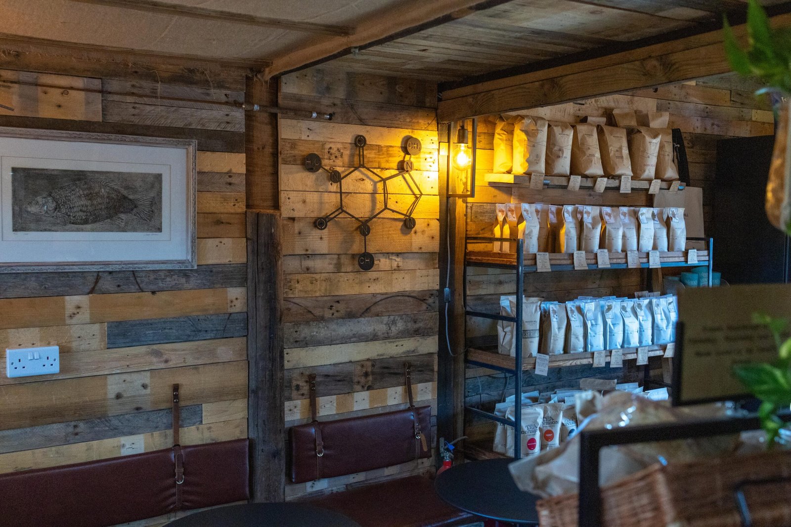 Interior of the Maulden cafe with reclaimed pallet wood walls and a fish print on the wall