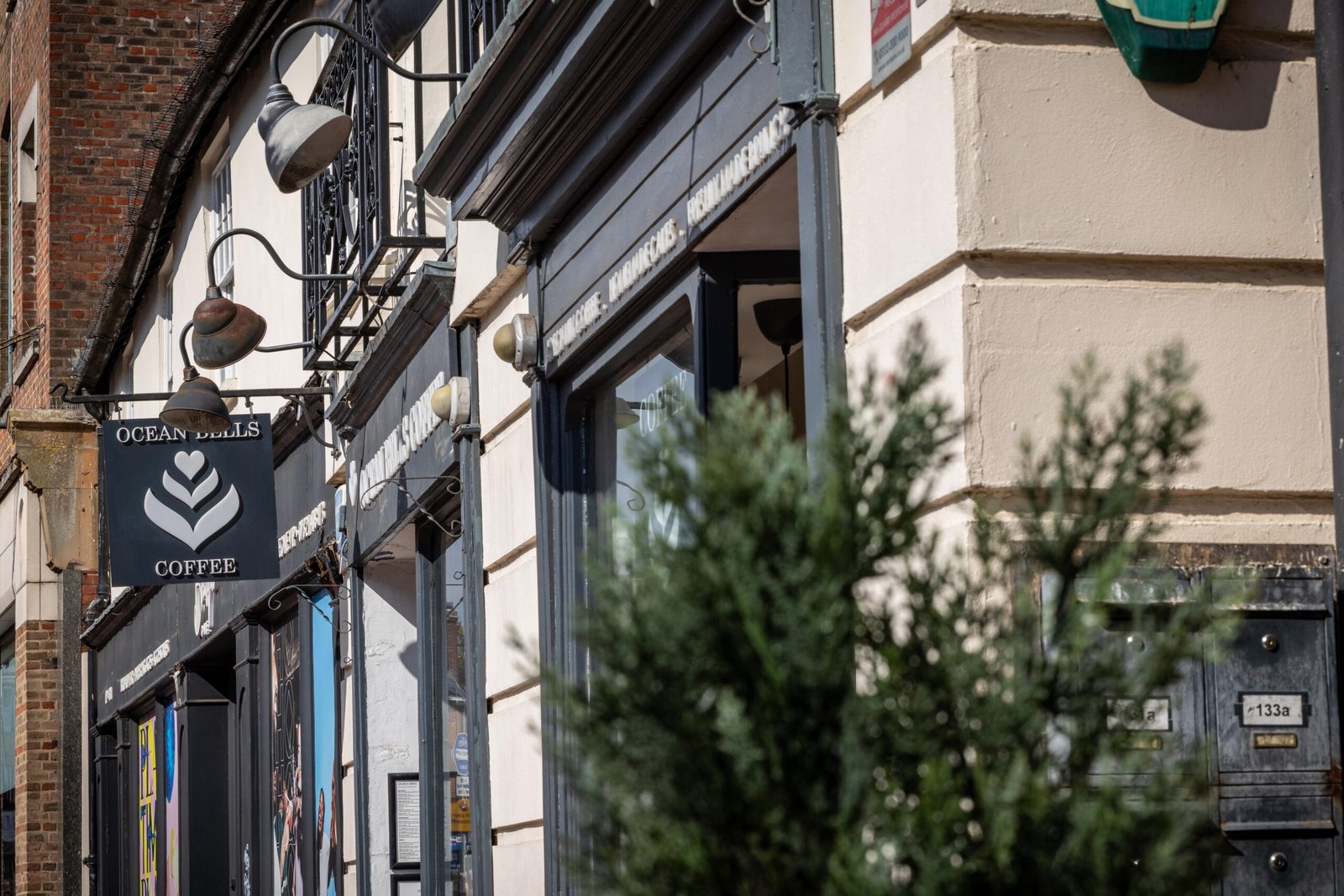 The Ocean Bells Coffee hanging sign above the shopfront