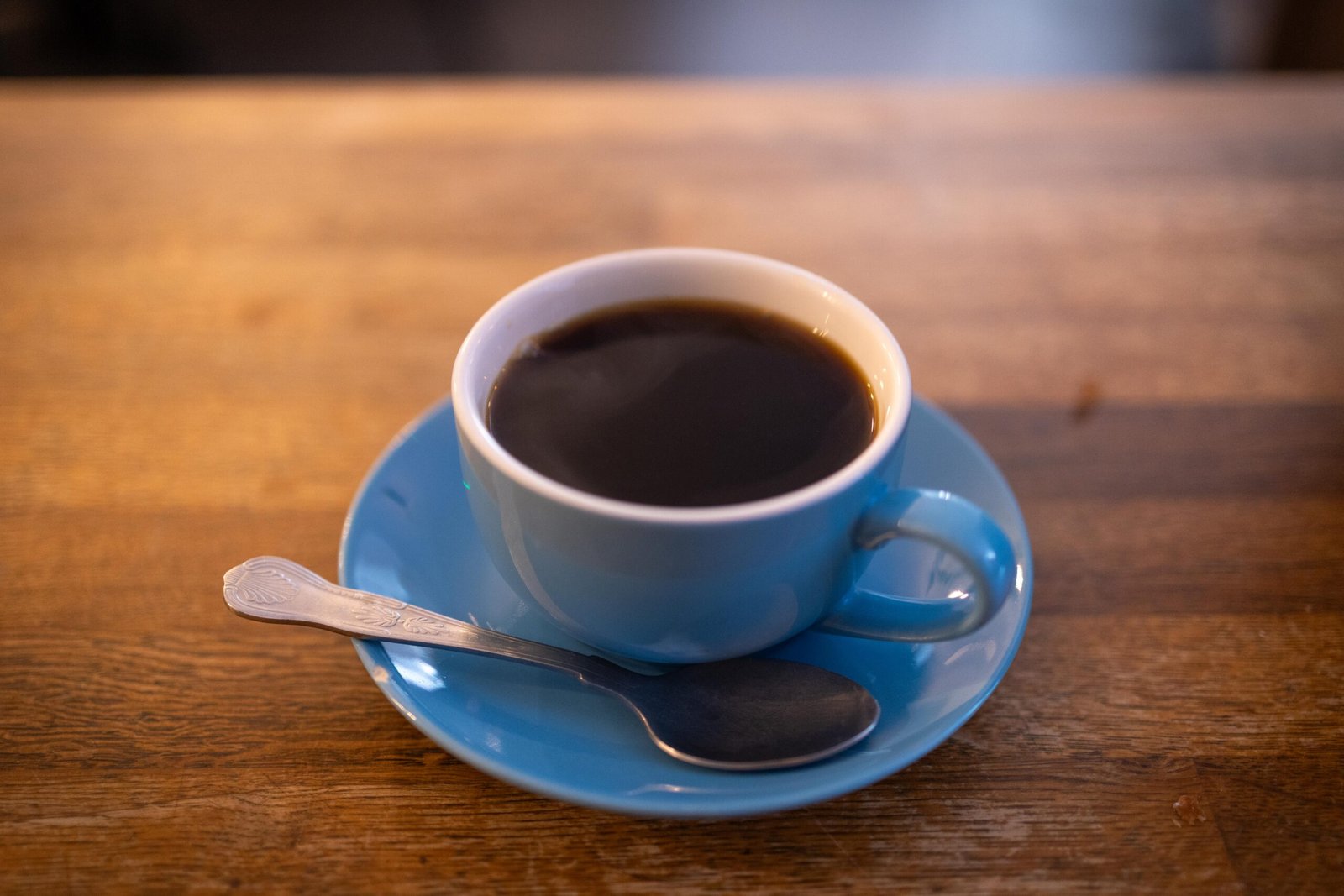 The large chalkboard menu listing espresso drinks and loose-leaf teas