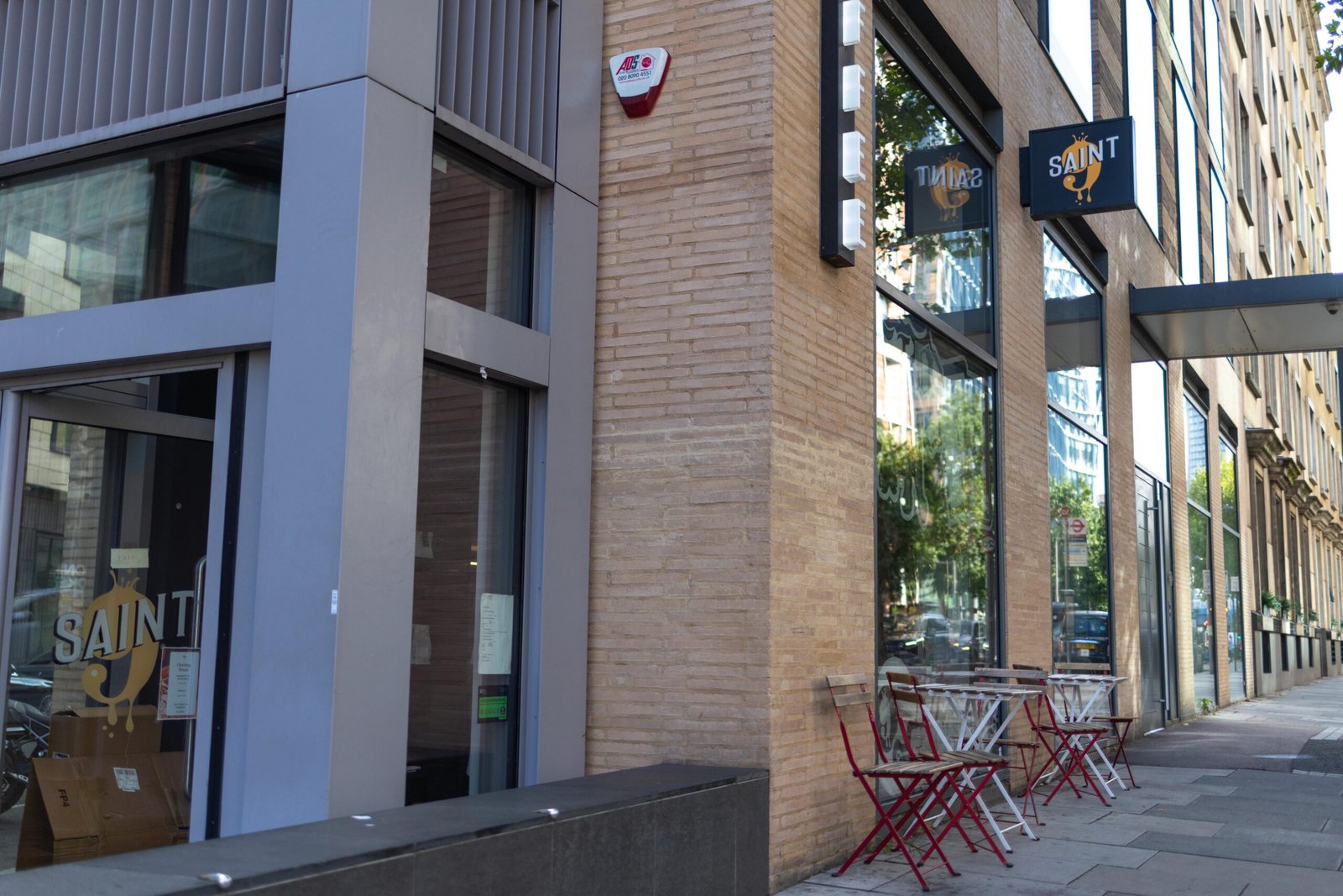 The exterior of Saint Nine Coffee on Southwark Street, with gold SAINT signage and outdoor seating