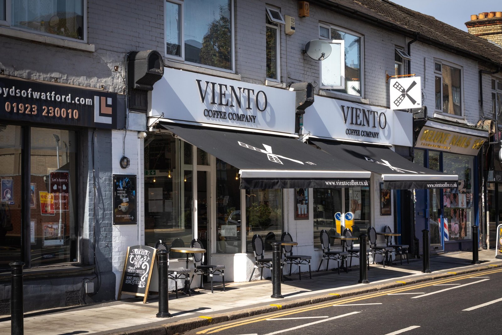 The Viento Coffee Company shopfront with black branded awnings and windmill logo