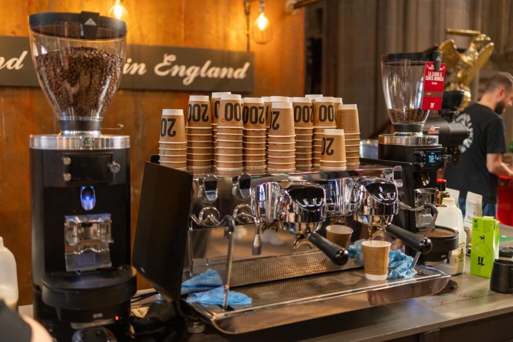Espresso machine, grinders and stacked paper cups at the 200 Degrees Coffee stand at Nottingham Coffee Festival