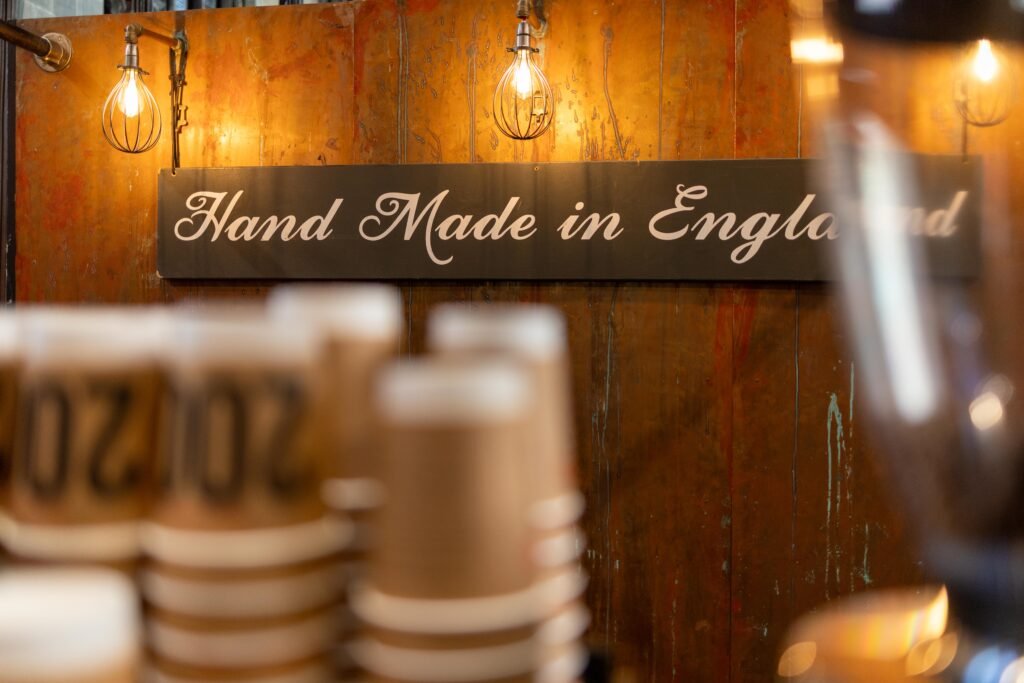 Hand Made in England sign above stacked 200 Degrees Coffee paper cups