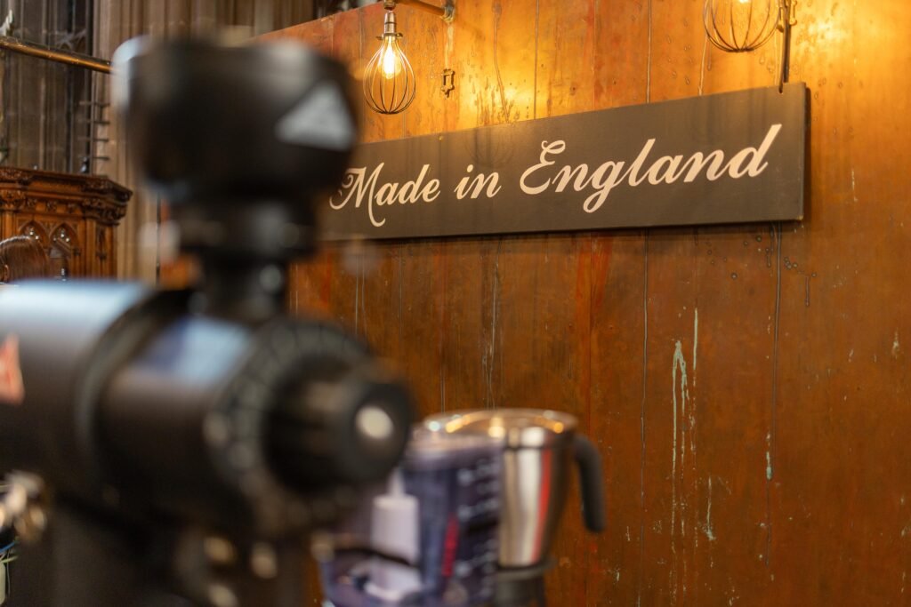Hand Made in England sign on a wooden wall at the 200 Degrees Coffee stand, with a coffee grinder in the foreground