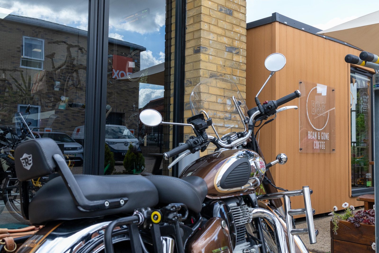 A motorcycle parked outside the Bean & Gone Coffee kiosk in Hertford