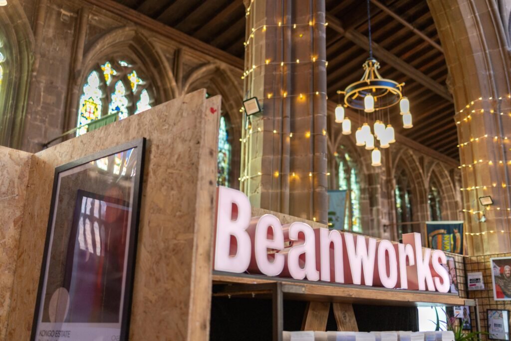 Beanworks lettering on the stand beneath the arched roof and fairy lights of St Mary's Church