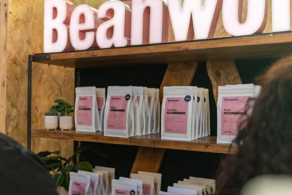 Shelves of Beanworks coffee bags beneath the Beanworks sign