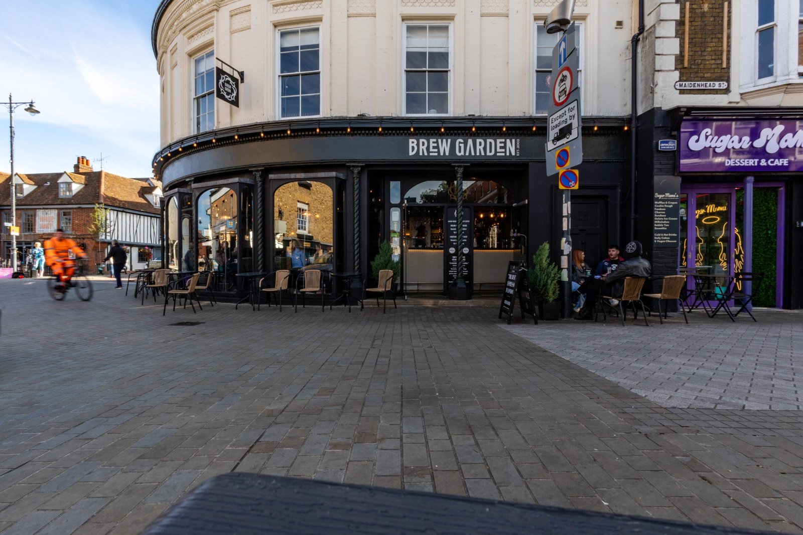 The curved corner building housing Brew Garden, among the best coffee shops in Hertford