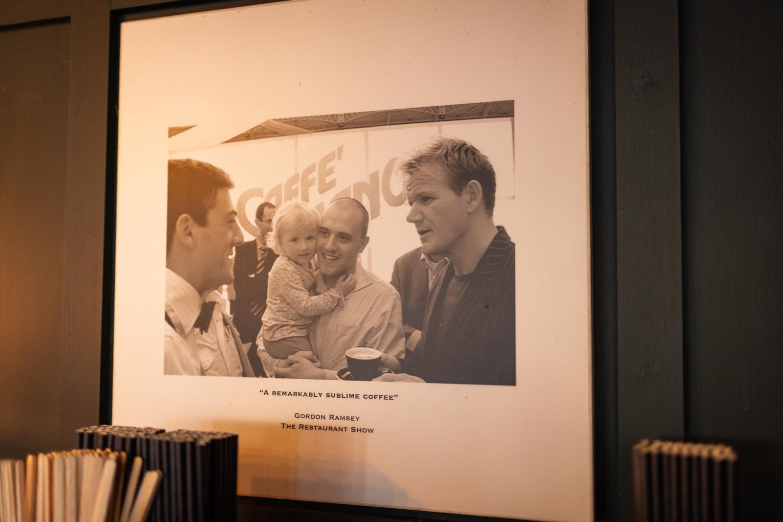 Framed black and white photograph hanging on the wall at Brew Garden