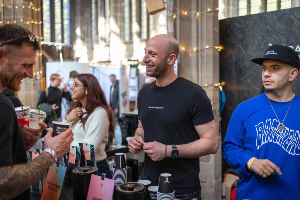 Cartwheel Coffee Roasters team members laughing and chatting with visitors at the stand