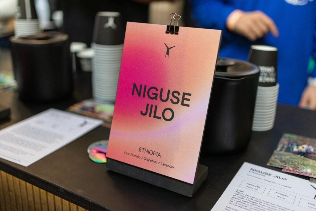 A pink card for Niguse Jilo, an Ethiopian coffee, on the Cartwheel Coffee Roasters stand