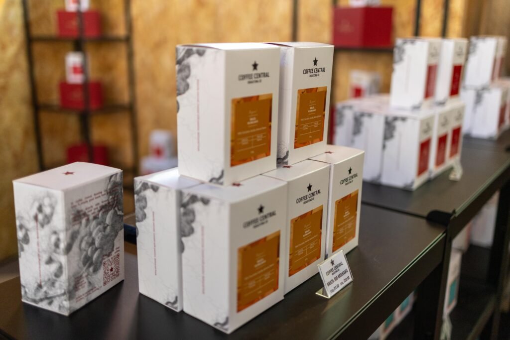 Stacked white boxes of Coffee Central Roasting Co coffee on a counter