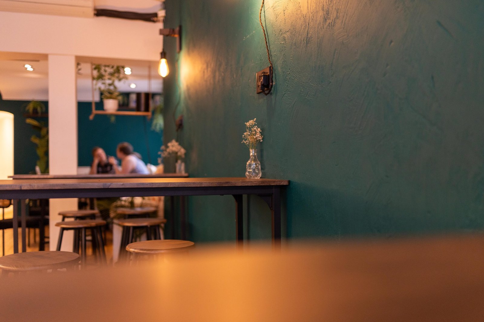 Seating and teal walls inside Cult Club Coffee
