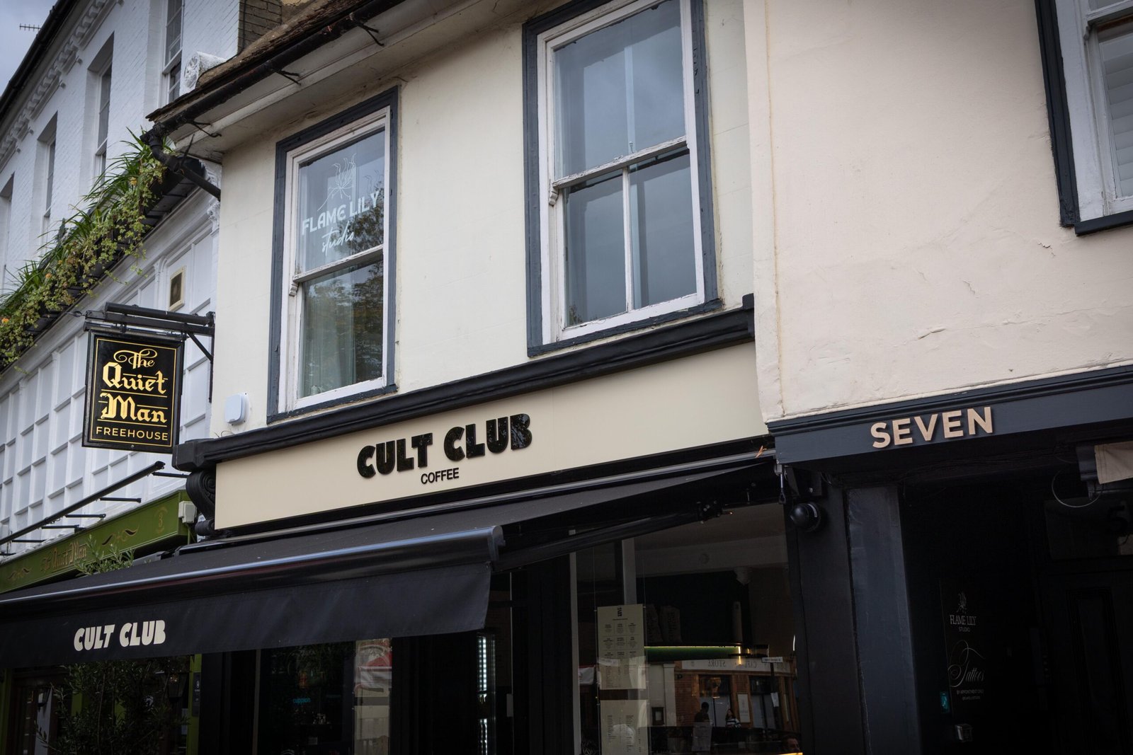 The black and cream frontage of Cult Club Coffee in Hertford