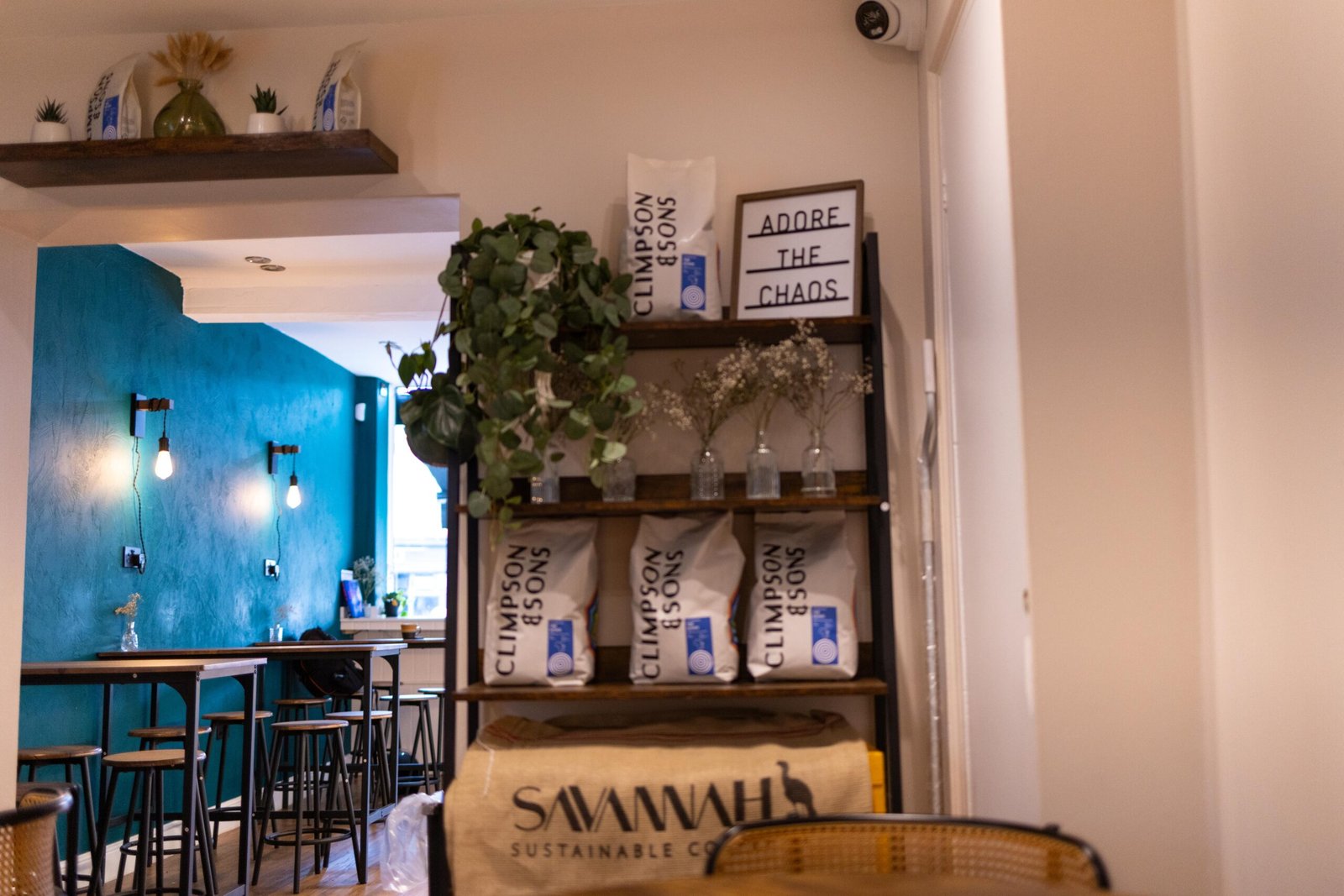 Shelves of coffee bags and seating at the back of Cult Club Coffee