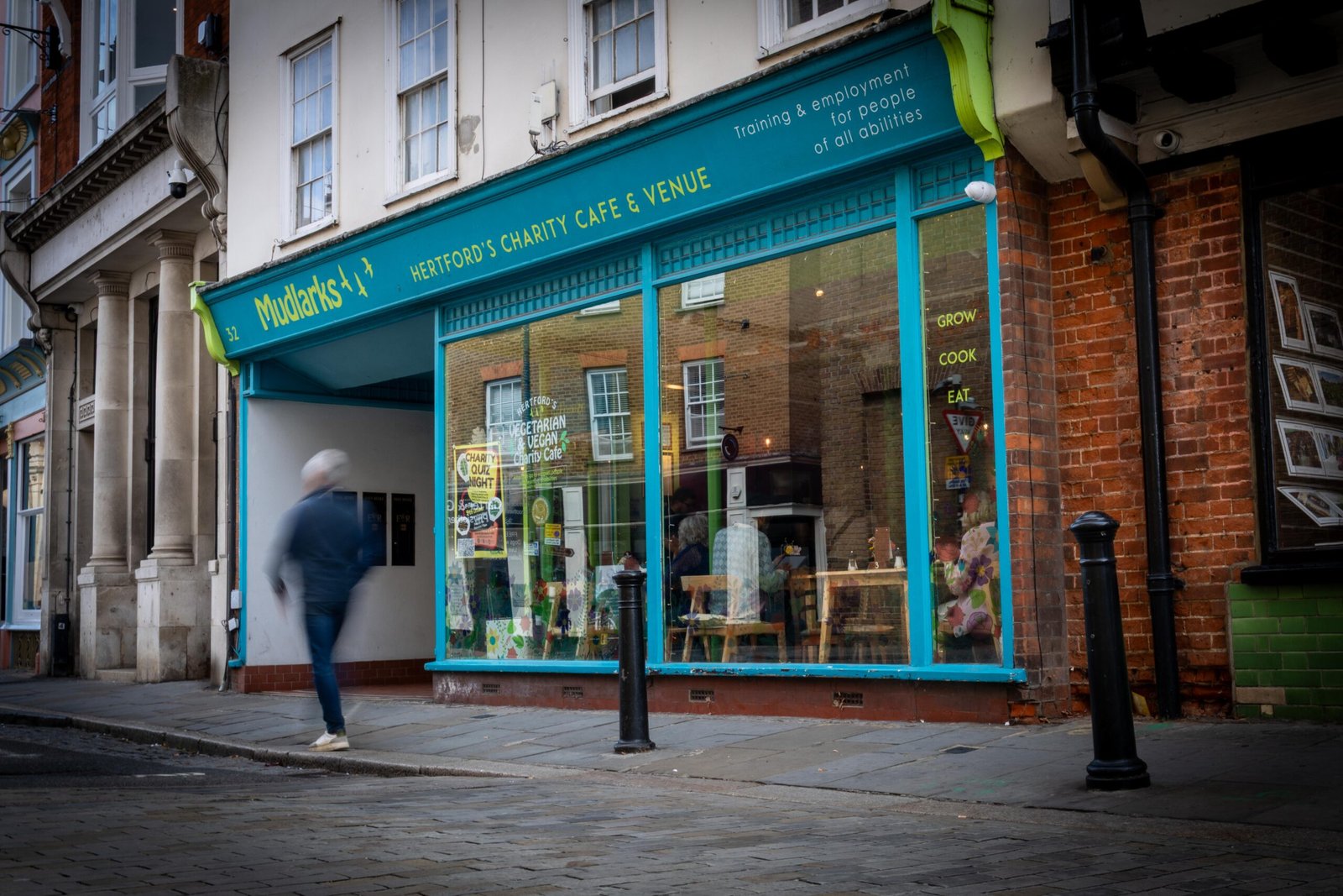 The teal shopfront of Mudlarks Garden Cafe, one of the most community-minded coffee shops in Hertford