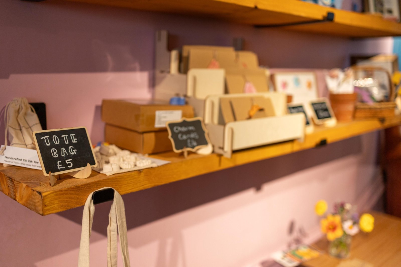 Shelf of tote bags and gifts at Mudlarks Garden Cafe