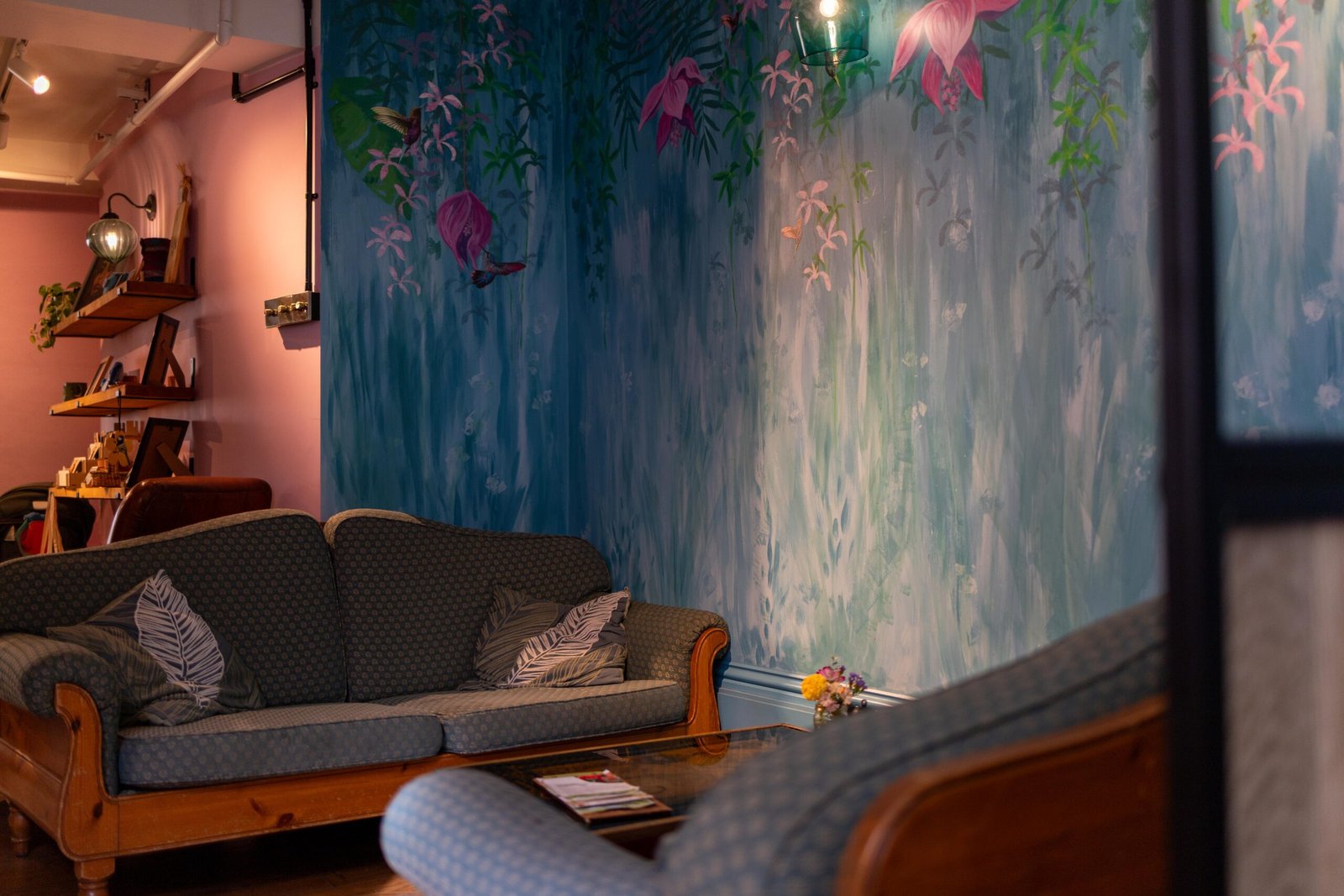 Sofa and painted mural inside Mudlarks Garden Cafe