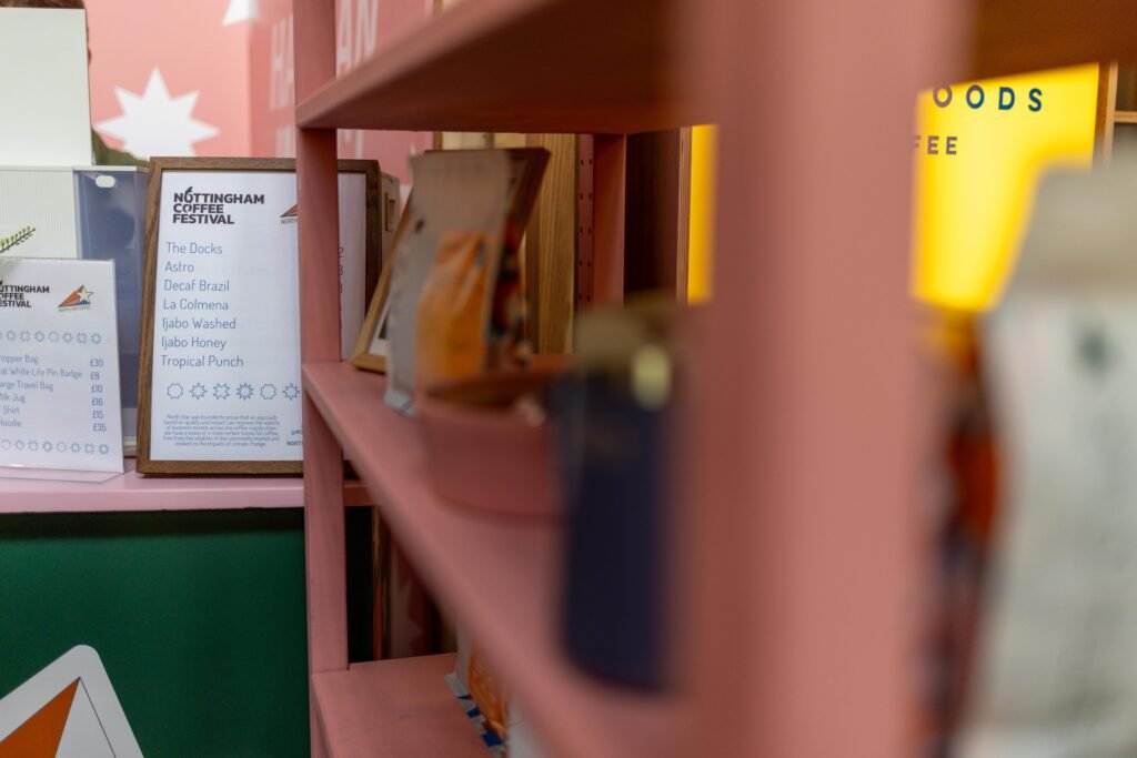 A framed Nottingham Coffee Festival menu on a North Star Coffee shelf