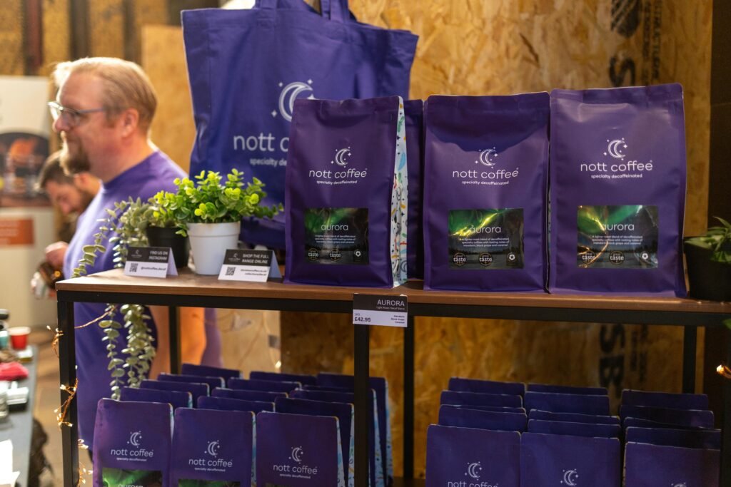 Purple Nott Coffee decaf bags on a shelf at the Nott Coffee stand at Nottingham Coffee Festival