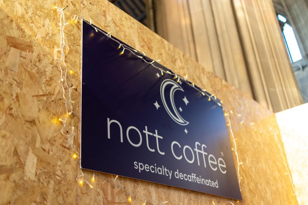 Nott Coffee Specialty Decaffeinated sign with a crescent moon logo on a wooden board