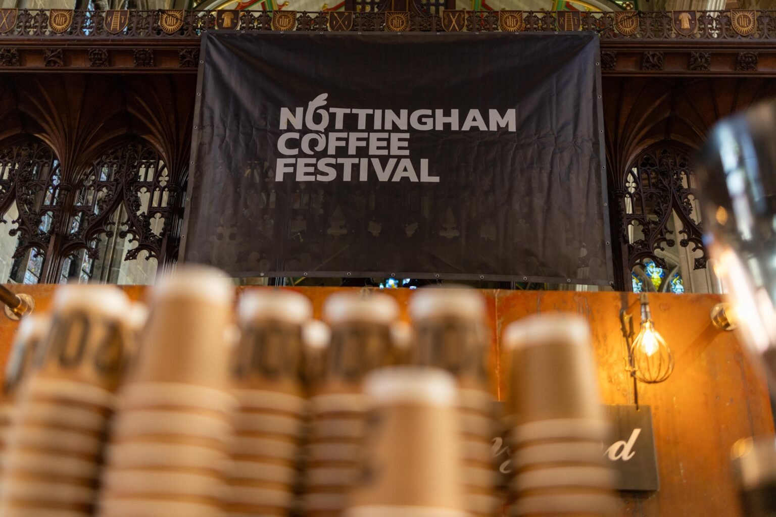 Nottingham Coffee Festival banner hanging above stacked 200 Degrees Coffee cups inside St Mary's Church