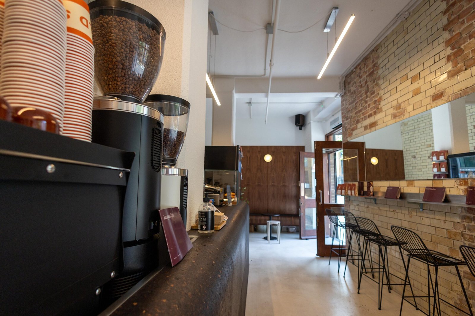 Interior of the Old Spike cafe in Southwark, with coffee grinders, bar seating and exposed brick