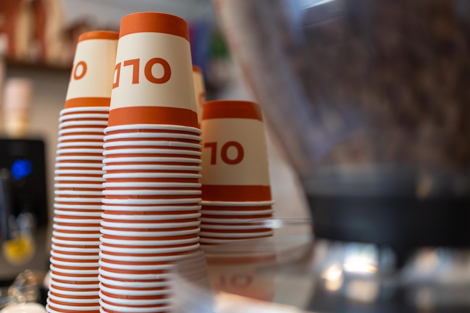 Close-up of orange and white Old Spike takeaway cups