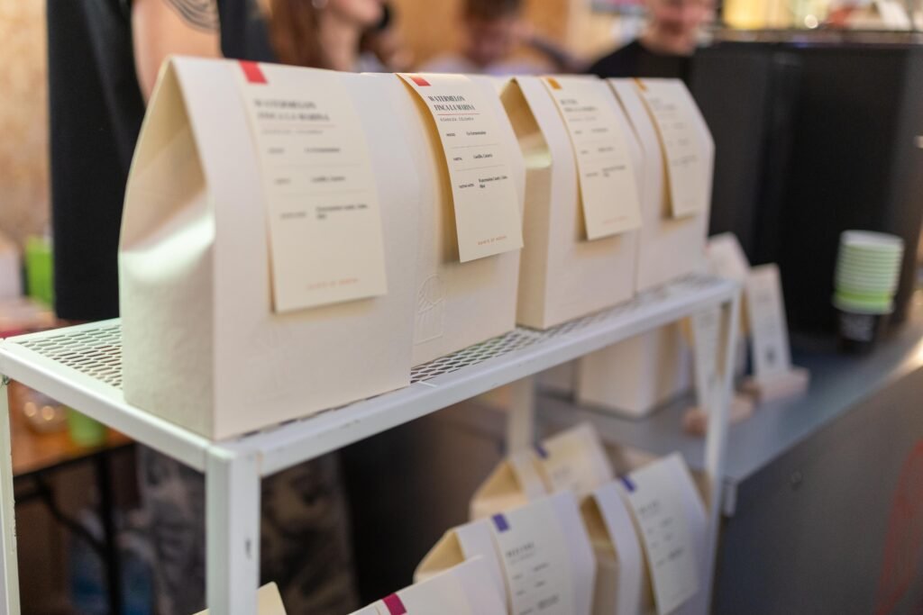 Cream Saints of Mokha coffee bags with handwritten labels on a white shelf